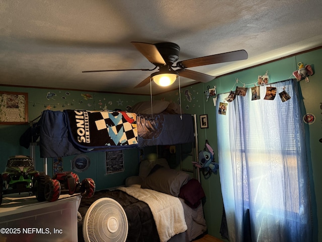 bedroom with a textured ceiling and ceiling fan