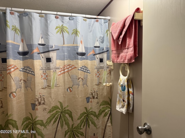 full bathroom with a shower with curtain and a textured ceiling