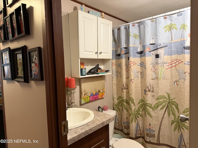 full bathroom with vanity, a shower with curtain, toilet, and a textured ceiling