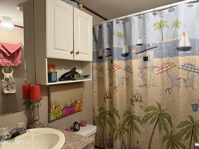 full bathroom with toilet, a textured ceiling, curtained shower, and a sink