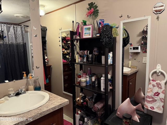 bathroom with vanity, a textured ceiling, and a shower with shower curtain
