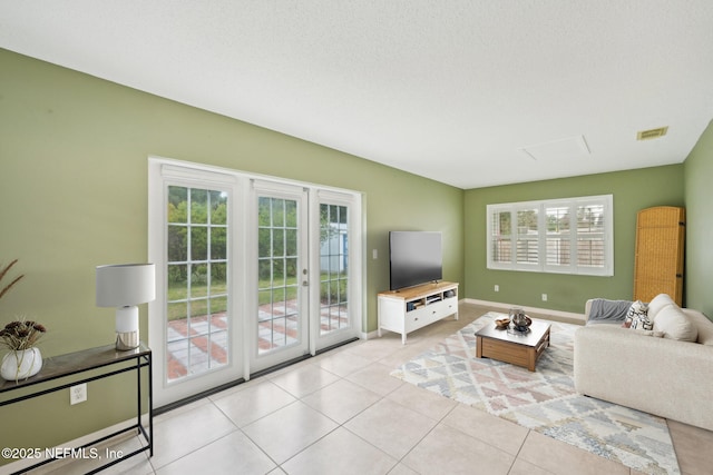 369 Altara Dr, Saint Augustine, FL 32086 - living area featuring light tile patterned flooring, french doors, and baseboards