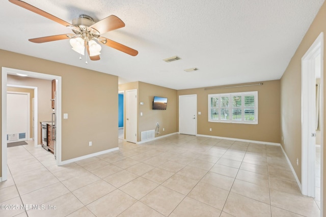 369 Altara Dr, Saint Augustine, FL 32086 - unfurnished room with a ceiling fan, light tile patterned floors, baseboards, and a textured ceiling