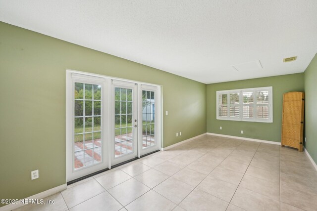 369 Altara Dr, Saint Augustine, FL 32086 - spare room featuring baseboards, french doors, and light tile patterned floors