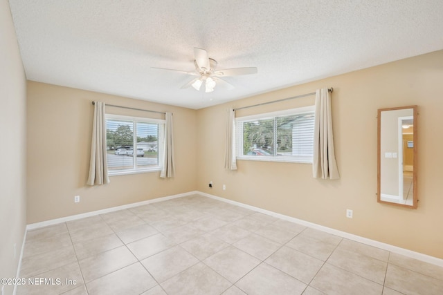 369 Altara Dr, Saint Augustine, FL 32086 - empty room featuring a ceiling fan, light tile patterned floors, baseboards, and a textured ceiling