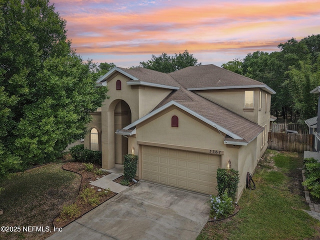 3367 Turkey Creek Dr, Green Cove Springs, FL 32043 - traditional-style home featuring stucco siding, an attached garage, driveway, and roof with shingles
