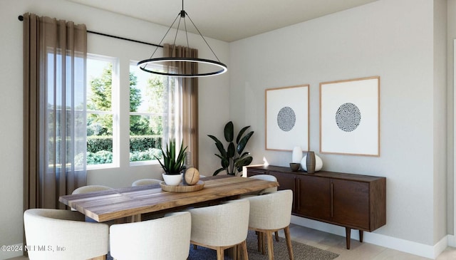 dining room with an inviting chandelier and baseboards