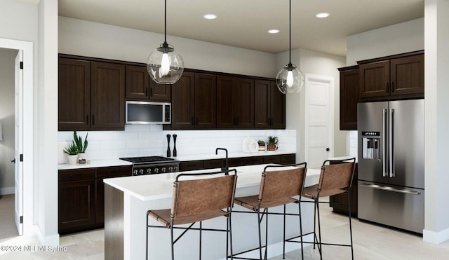 kitchen featuring dark brown cabinetry, appliances with stainless steel finishes, light countertops, decorative light fixtures, and tasteful backsplash