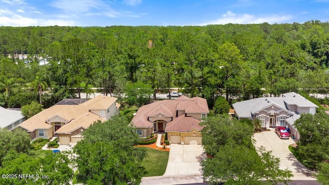 aerial view of residential area with a heavily wooded area