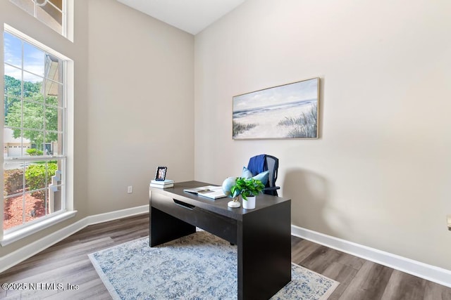 office area with wood finished floors, baseboards, and plenty of natural light