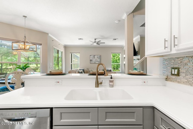 kitchen with gray cabinets, stainless steel dishwasher, a sink, and a chandelier