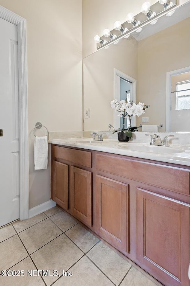 full bath with tile patterned flooring and double vanity