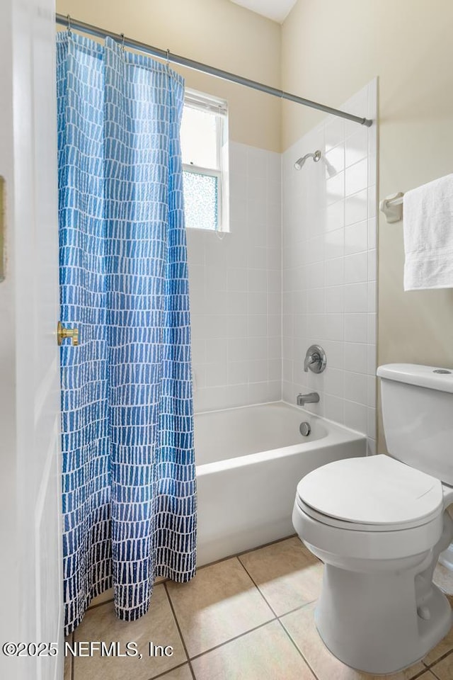 bathroom featuring toilet, tile patterned flooring, and shower / tub combo with curtain