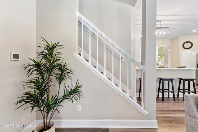 stairway featuring wood finished floors