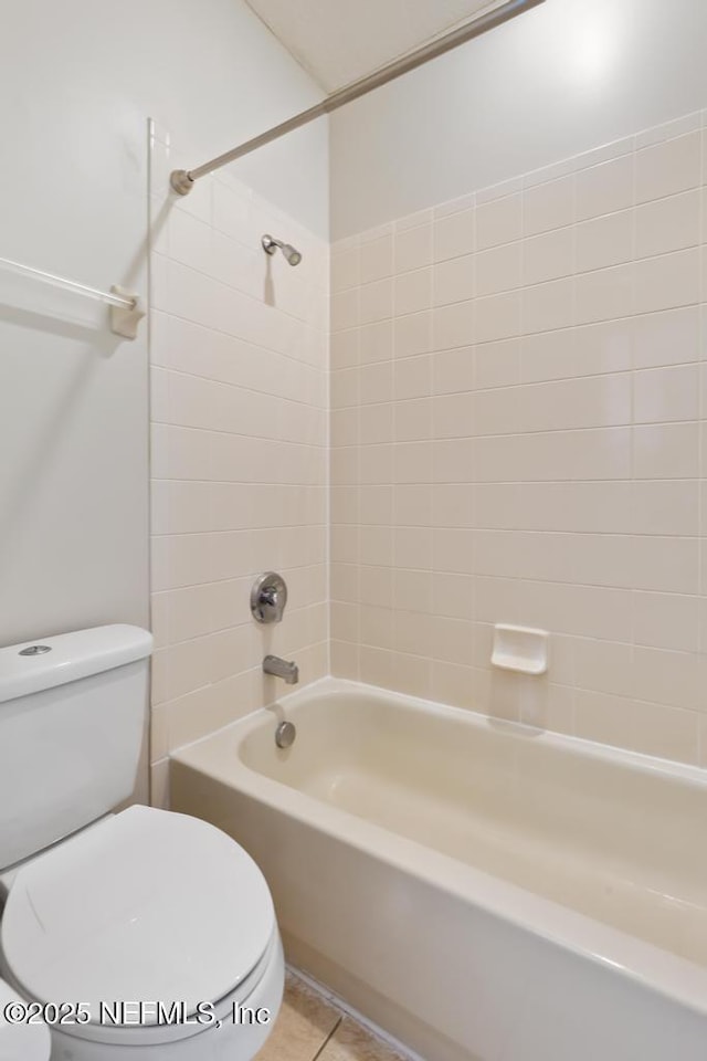 bathroom featuring toilet, shower / bathtub combination, and tile patterned flooring