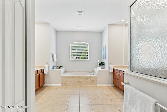 bathroom featuring vanity, a bath, recessed lighting, tile patterned flooring, and baseboards