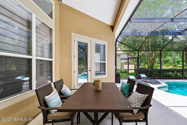 view of patio featuring an outdoor pool and glass enclosure