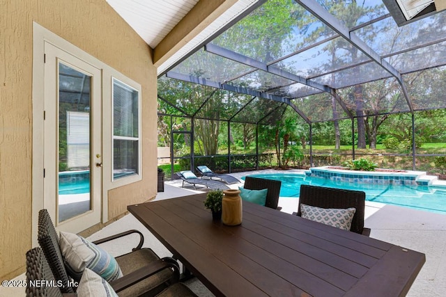 outdoor pool with a patio area, outdoor dining area, and a lanai