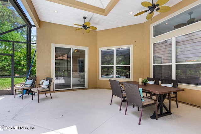 sunroom / solarium featuring a ceiling fan, plenty of natural light, outdoor dining space, and recessed lighting