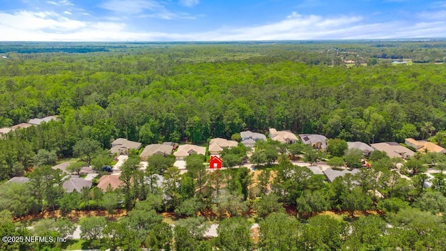aerial perspective of suburban area featuring a heavily wooded area