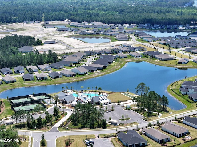 aerial view with a water view, a view of trees, and a residential view