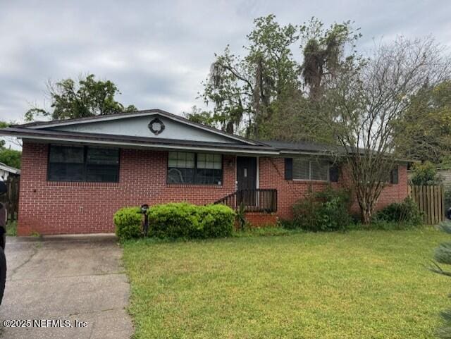 ranch-style home with brick siding and a front yard