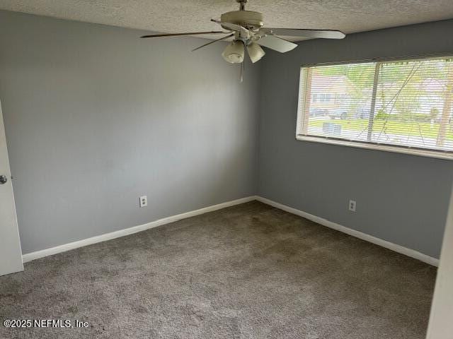 carpeted empty room with baseboards, a textured ceiling, and ceiling fan