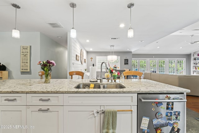 11136 River Creek Dr W, Jacksonville, FL 32223 - kitchen with a sink, open floor plan, stainless steel dishwasher, white cabinetry, and recessed lighting