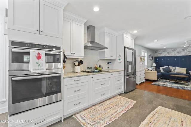 11136 River Creek Dr W, Jacksonville, FL 32223 - kitchen featuring wall chimney exhaust hood, stainless steel appliances, open floor plan, white cabinets, and recessed lighting