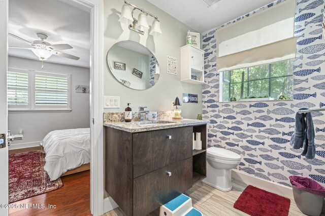 11136 River Creek Dr W, Jacksonville, FL 32223 - full bath featuring wood finished floors, baseboards, toilet, ceiling fan, and vanity