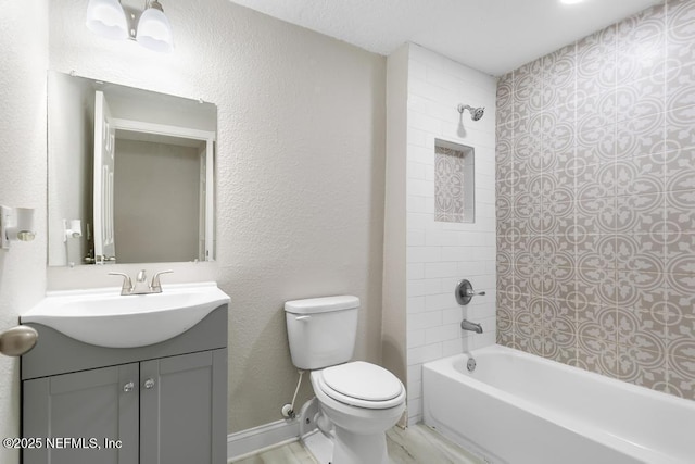 full bath featuring bathing tub / shower combination, baseboards, vanity, and toilet