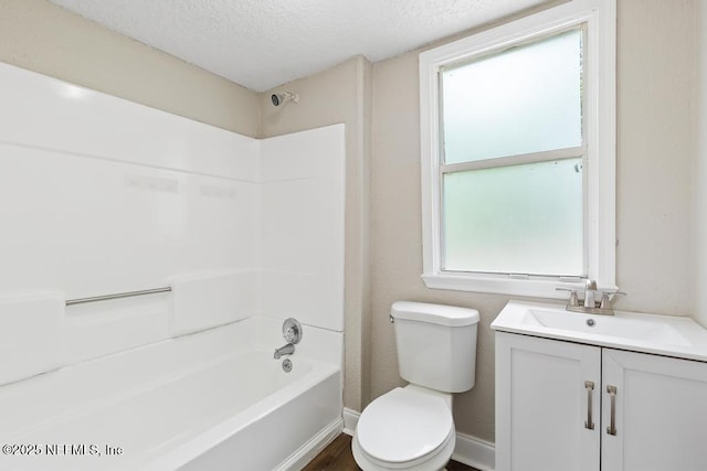 bathroom with shower / tub combination, a textured ceiling, a healthy amount of sunlight, and toilet