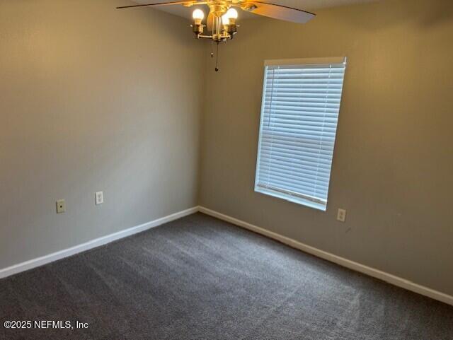 carpeted empty room with baseboards and a ceiling fan