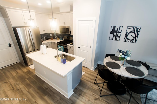 11104 Motion Ct, Jacksonville, FL 32256 - kitchen featuring a sink, appliances with stainless steel finishes, backsplash, and dark wood-style floors