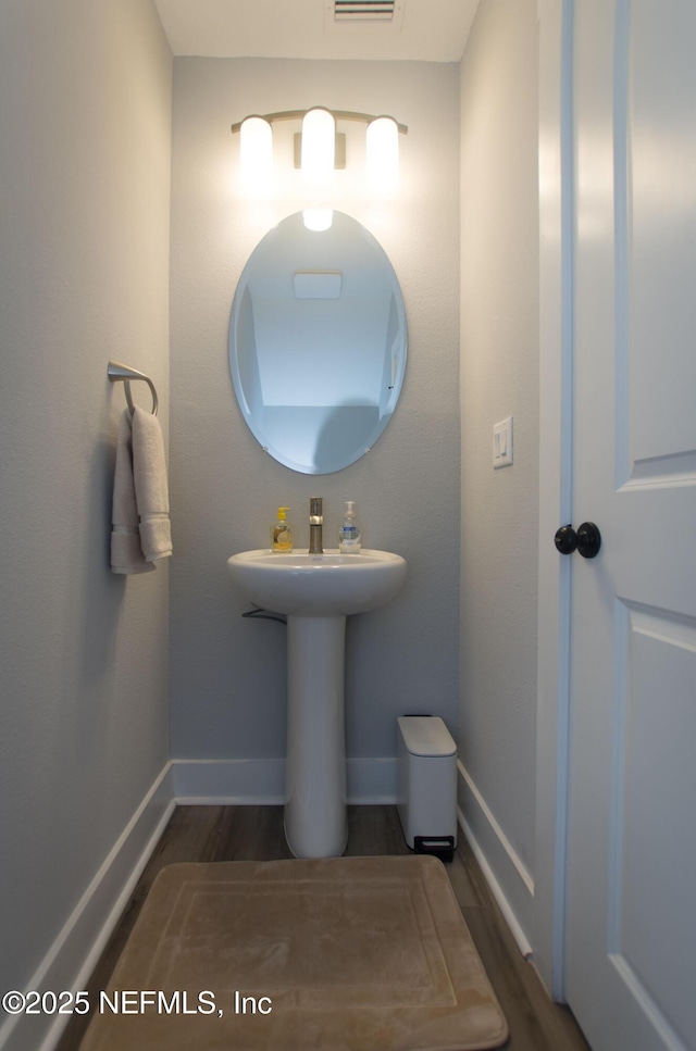 11104 Motion Ct, Jacksonville, FL 32256 - bathroom with baseboards and wood finished floors