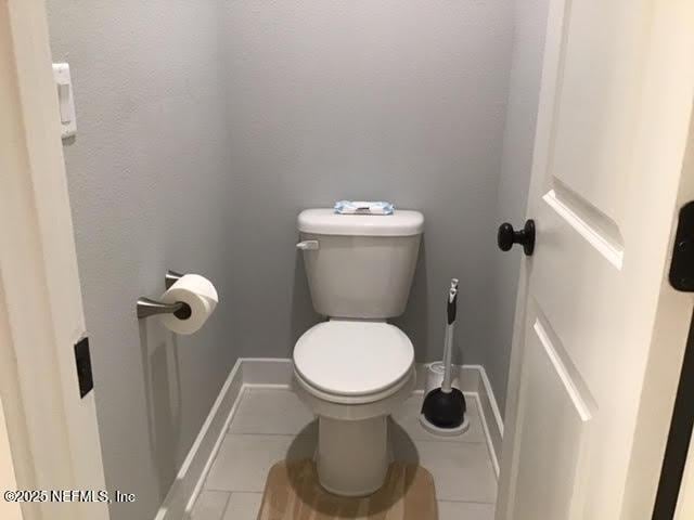11104 Motion Ct, Jacksonville, FL 32256 - bathroom with tile patterned floors, baseboards, and toilet