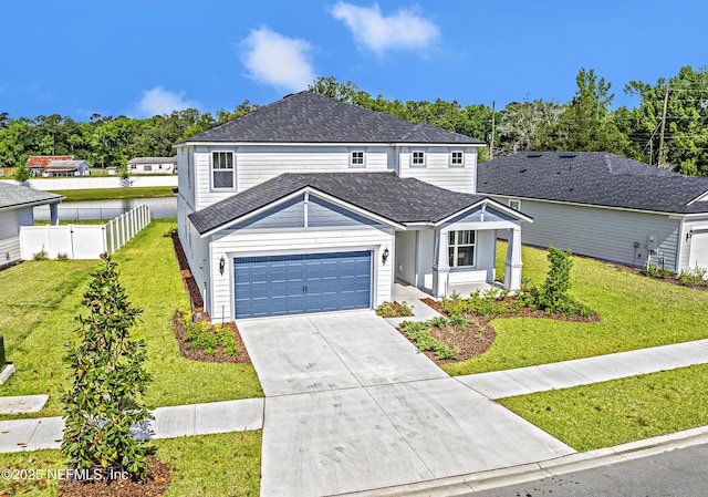 traditional home with a garage, a front lawn, fence, roof with shingles, and driveway