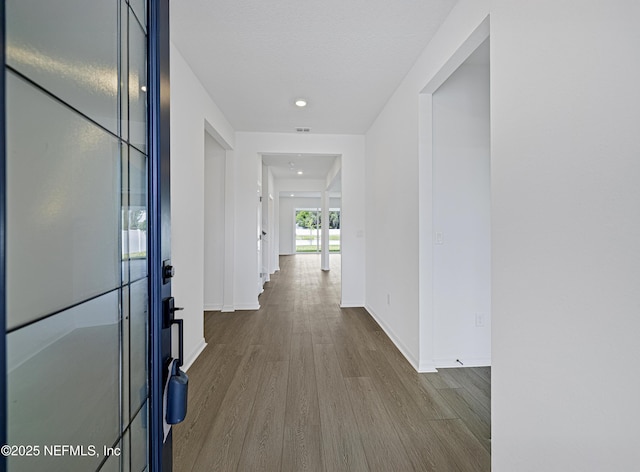 hall with baseboards, recessed lighting, and wood finished floors