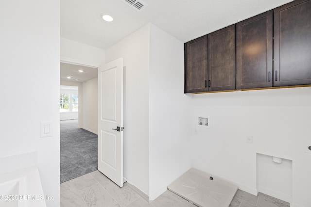 clothes washing area with visible vents, baseboards, hookup for a washing machine, electric dryer hookup, and cabinet space