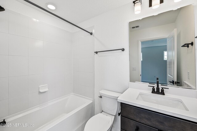 bathroom featuring toilet, visible vents, shower / washtub combination, and vanity