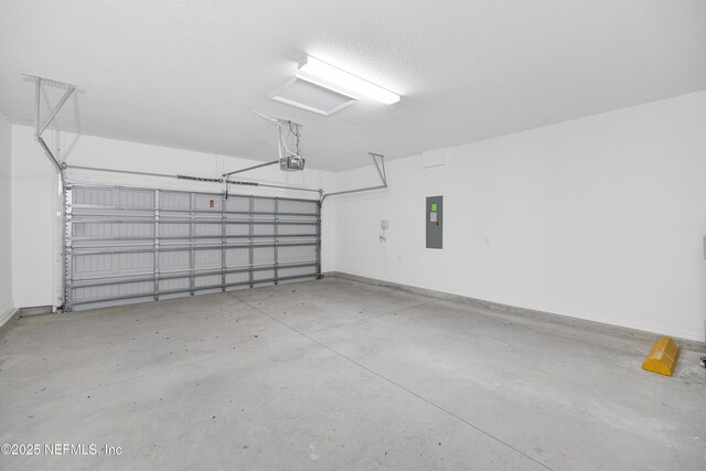 garage featuring baseboards, a garage door opener, and electric panel