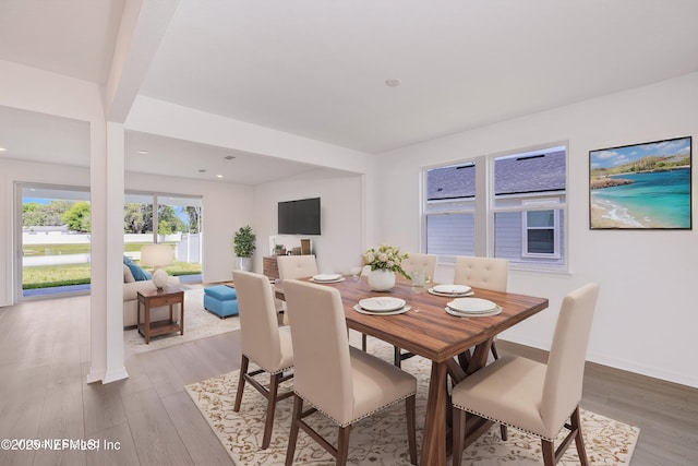 dining space featuring recessed lighting, baseboards, and wood finished floors