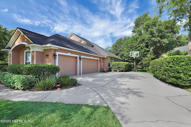 521 S Bridge Creek Dr, Saint Johns, FL 32259 - view of home's exterior with an attached garage, concrete driveway, and stucco siding