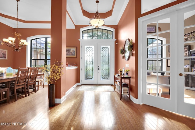 521 S Bridge Creek Dr, Saint Johns, FL 32259 - entrance foyer with a chandelier, french doors, baseboards, wood-type flooring, and crown molding