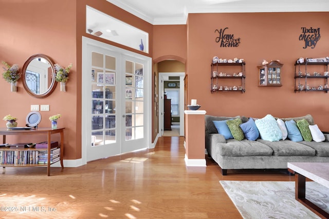 521 S Bridge Creek Dr, Saint Johns, FL 32259 - living room with arched walkways, crown molding, baseboards, wood finished floors, and french doors