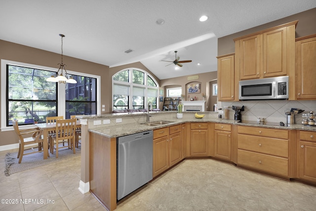521 S Bridge Creek Dr, Saint Johns, FL 32259 - kitchen featuring appliances with stainless steel finishes, a sink, a peninsula, ceiling fan, and light stone counters
