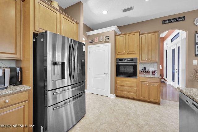 521 S Bridge Creek Dr, Saint Johns, FL 32259 - kitchen featuring stainless steel appliances, arched walkways, light stone counters, baseboards, and light brown cabinets