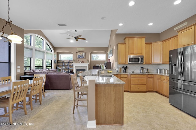 521 S Bridge Creek Dr, Saint Johns, FL 32259 - kitchen with fridge with ice dispenser, stainless steel microwave, a sink, a peninsula, and a ceiling fan