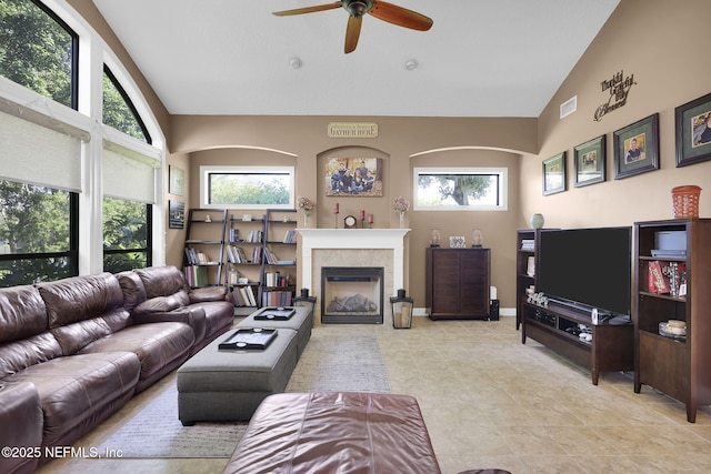 521 S Bridge Creek Dr, Saint Johns, FL 32259 - living room with vaulted ceiling, ceiling fan, a glass covered fireplace, and baseboards