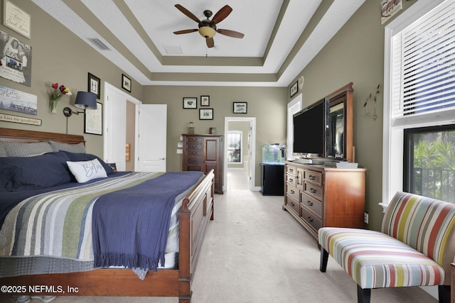 521 S Bridge Creek Dr, Saint Johns, FL 32259 - bedroom with a tray ceiling, light colored carpet, multiple windows, and ceiling fan